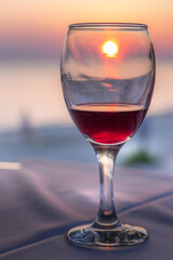 Romantic glass of wine on the beach at sunset