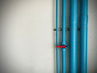 Blue PVC Piping System of Water Supply, Industrial interior of water pump. Valves. Pressure gauges. Motors inside engine room. Valve and pumps in an industrial room.