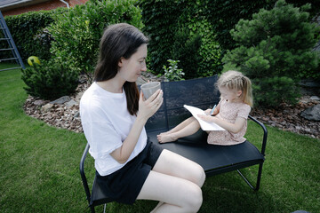 Woman and a child learning in the backyard