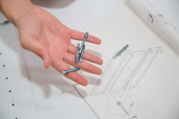 man's hand holding screws