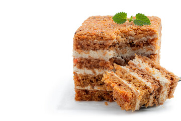 Piece of homemade carrot cake isolated on white background