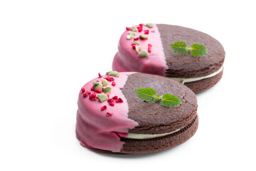 Chocolate cookies with cream and pink glaze isolated on white
