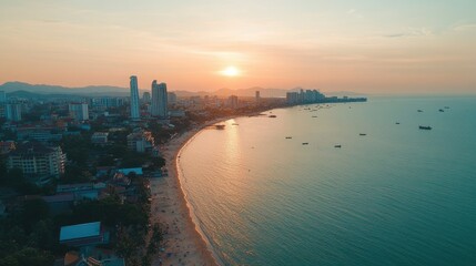 Fototapeta premium A drone shot of Pattaya city during the day, showing the harmony between the urban area and the natural coastline.