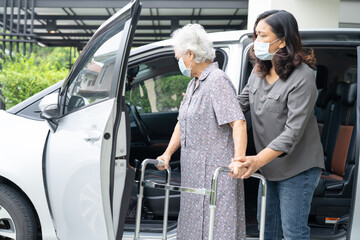 Asian senior woman patient sitting on walker prepare get to her car, healthy strong medical concept.