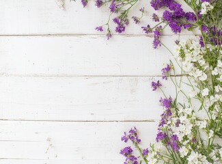 Fototapeta premium An empty space is available for publicity information or advertising text on top of a bouquet of dried wild flowers on a white table background with vintage planks of wood texture with a natural wood