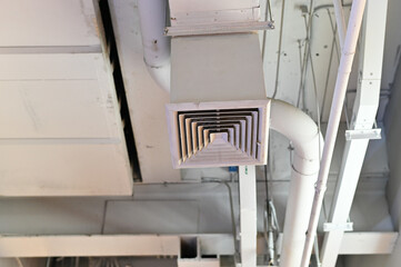 Ceiling mounted ventilation duct in an industrial style interior..