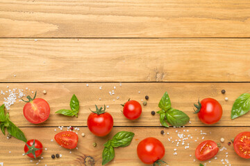 Fresh tomatoes, basil, sea salt and spices on wooden background, top view