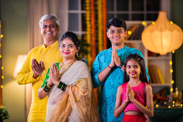 Indian family in prayer or greeting pose, celebrating Diwali festival with devotion and warmth