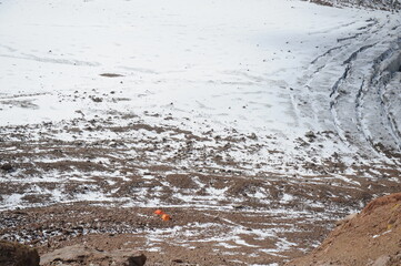 A tent in a hollow among the mountains.