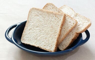 slices Wholemeal bread in ceramic bowl