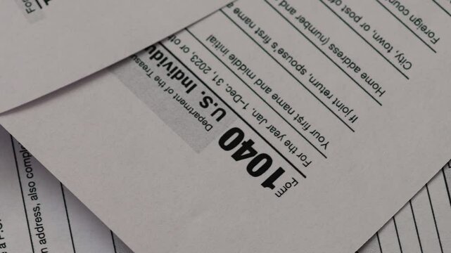 tax forms 1040 for individuals us close up rotation , concept paying taxes , filing tax returns by us citizens