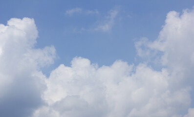 A blue sky with puffy clouds.