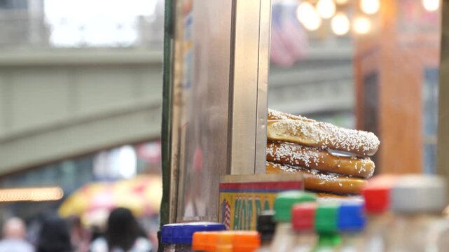New York City life, Manhattan Midtown 42 street. Fast food hot dog, street food kiosk. Defocused people pedestrian near Grand Central Terminal Station, Pershing Square Bridge USA. Precel, hotdog to go