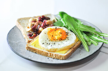 bread with egg and cheese topping or  sunny side up egg , lettuce and almond with dried cranberry