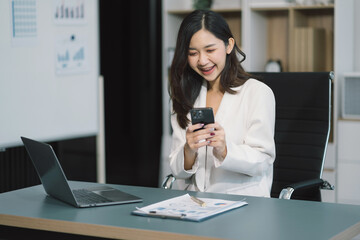 successful business women hand working with tablet and laptop computer with documents on office desk in modern office.