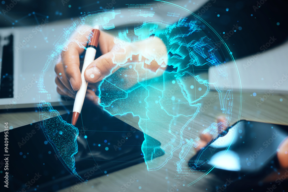 Poster close up of male hands using tablet and cellphone at office desk with glowing polygonal globe hologr