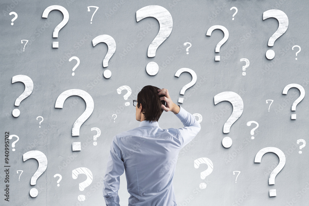 Poster back view of young businessman on concrete wall background with question marks. solution and confusi