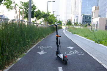 Electric scooter on the bicycle line in the city