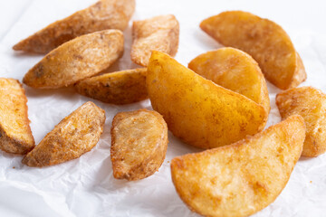 Fried potato wedges isolated on white background. Close up