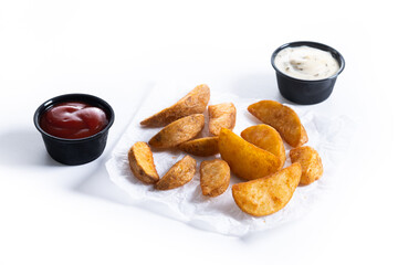 Fried potato wedges with sauces isolated on white background.