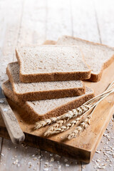 Healthy wholemeal bread slices on rustic wooden table