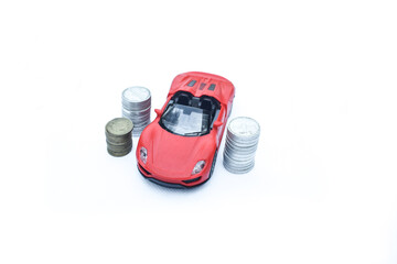 Fototapeta premium Car model on money coins pile. Finance and car loan, saving money for a car, coins insurance, loan and buying car finance concept. buy and installments with white Backgound