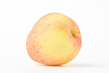Fresh ripe apple with tiny water drops on white background