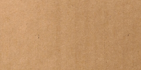 Fototapeta premium Brown eco recycled kraft paper sheet texture cardboard background. Close up natural brown paper parchment background texture with dark nap fibers pattern for design craft