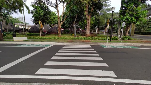 Video from bottom to top slowly and smoothly depicting the quiet zebra crossing in the morning