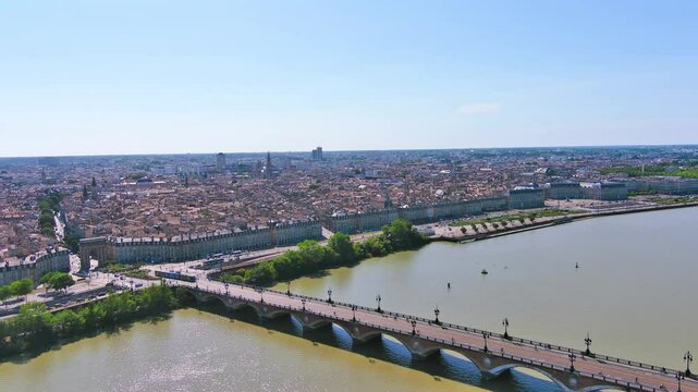 Bordeaux, France: Aerial view of famous French historic city, Roman-style stone arch Porte de Bourgogne and bridge Pont de Pierre, summer day with blue sky - landscape panorama of Europe from above

