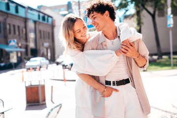 Smiling beautiful woman and her handsome boyfriend. Woman in casual summer clothes. Happy cheerful family. Female having fun. Couple posing in the street it sunny day. Cheerful and happy