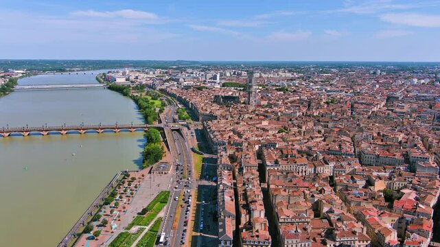 Bordeaux, France: Aerial view of famous French historic city, Roman-style stone arch Porte de Bourgogne and bridge Pont de Pierre, summer day with blue sky - landscape panorama of Europe from above
