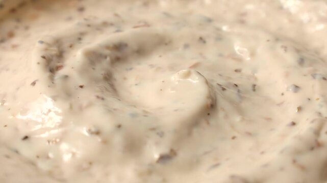 Creamy homemade mushroom dipping sauce texture circle rotation close up