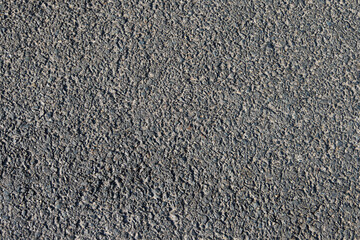 Texture of black asphalt pavement close up.