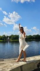 Girl in a Russian shirt on the river bank