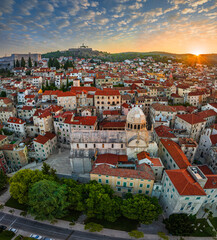 Sibenik, Croatia - Aerial vertical panoramic view of Saint James Cathedral of the old town of Sibenik on a sunny summer morning with Fortress of Saint Michael and golden sunrise by the Adriatic sea