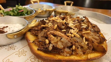 Sumac-Spiced Chicken Mssakhan – Tender Chicken Thighs with Caramelized Onions, Nuts, and Warm Flatbread