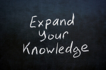 Chalk writing on a blackboard Expand your knowledge. Learning and personal growth.
