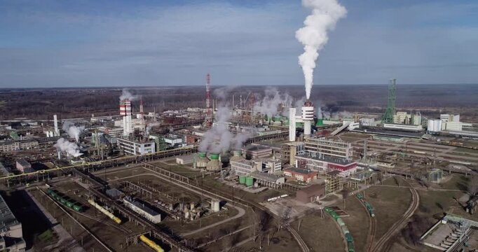 Chemistry Factory in Lithuania, Achema in Jonava City. Clear Blue Sky and Smoke Stacks in Background. Drone