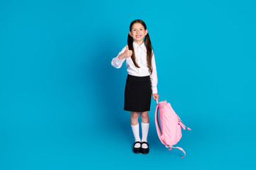 Full body portrait of little schoolchild thumb up wear uniform isolated on blue color background