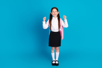 Full body portrait of little schoolchild raise fists empty space wear uniform isolated on blue color background