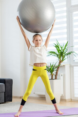 Child Exercising with Fitness Ball at Home.
