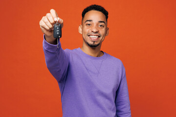 Young man of African American ethnicity wear purple sweatshirt casual clothes hold in hand give car...
