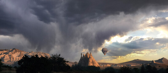 A hot air balloon floating in the skies of Cappadocia. Edited sky.