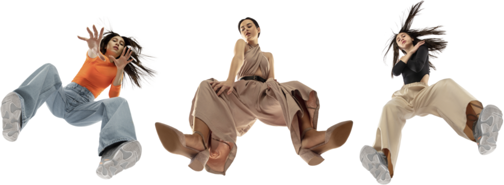 Three elegant young girls wearing diverse stylish clothes, blending streetwear and elegance, isolated on white background, shot from the bottom. Concept of fashion, youth, clothes, freedom