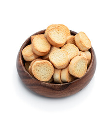 Crispy croutons in wooden bowl isolated on white background