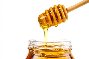 Carefully drizzling honey from a traditional wooden stick dipper into glass jar on white background
