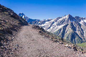 rocky dirt road through a pass in the highlands