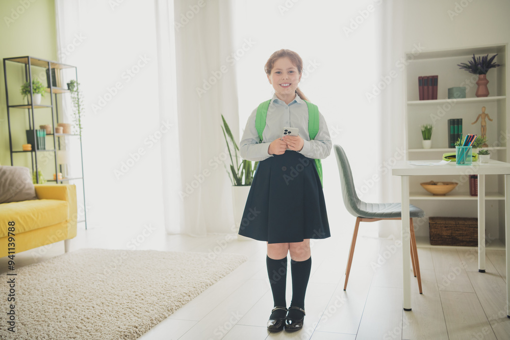 Canvas Prints Photo of cute adorable girl schoolkid going 1st september lesson standing room home flat interior indoors