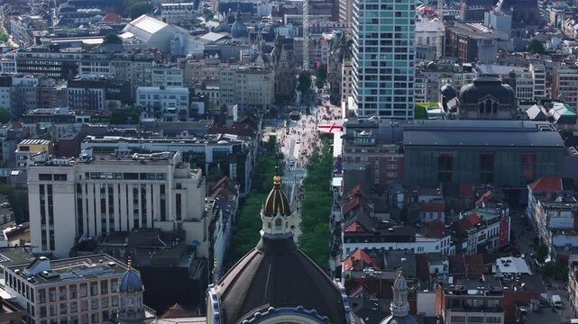 Aerial views capture meir street in Antwerp, Belgium, filled with people enjoying a sunny day. The scene blends modern and historic architecture, creating a lively urban vibe